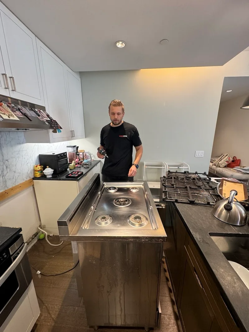 Elevate Repair technician servicing an appliance in a Buffalo home