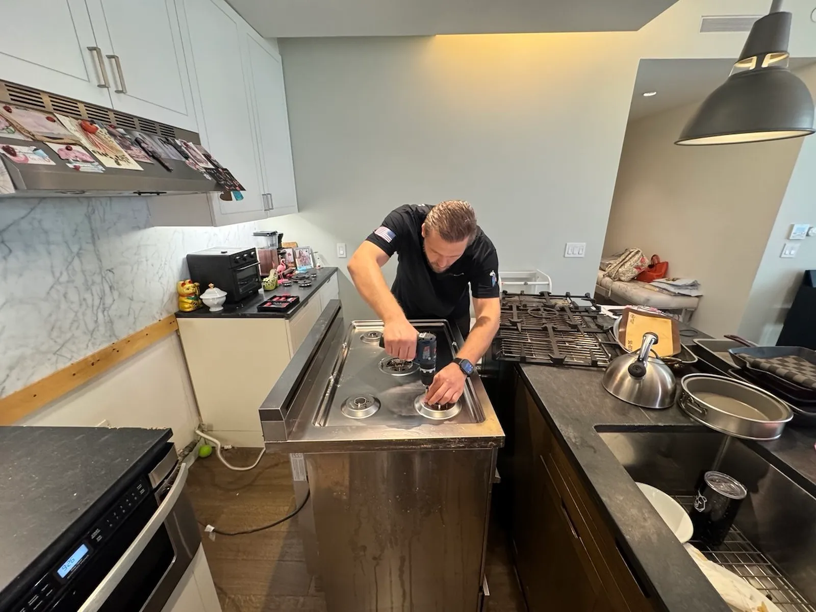 Elevate Repair technician repairing a cooktop in a Buffalo home