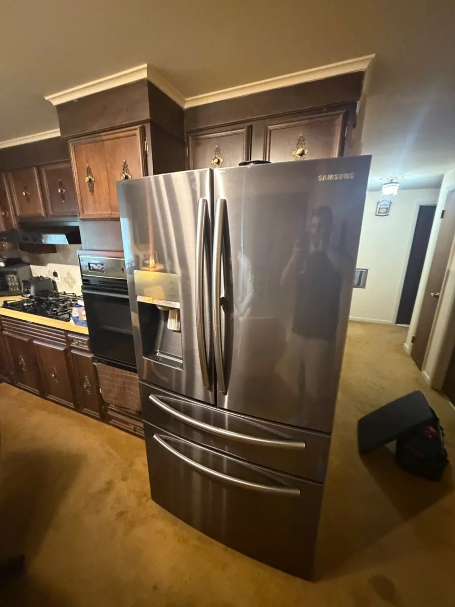 Stainless refrigerator with an ice and water dispenser in a Buffalo kitchen